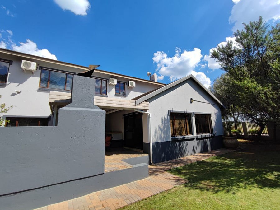 A double-storey house with its exterior painted grey and dark trim