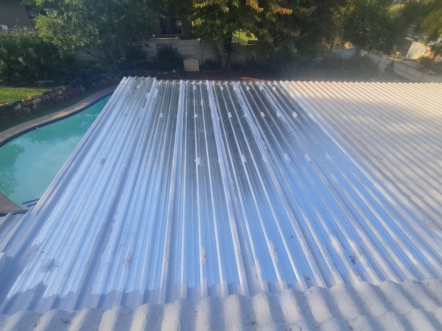 A low-pitch corrugated roof beside a swimming pool after waterproofing