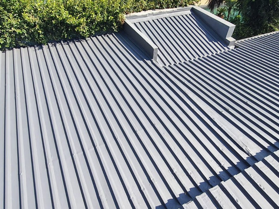 A dark grey steel roof with parapet walls