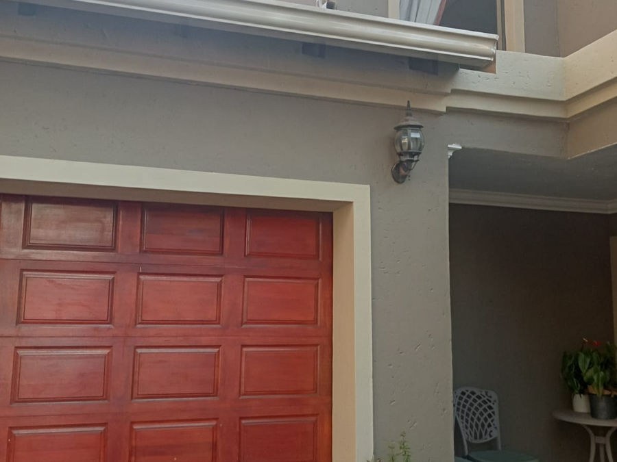 A red garage door set in a painted wall
