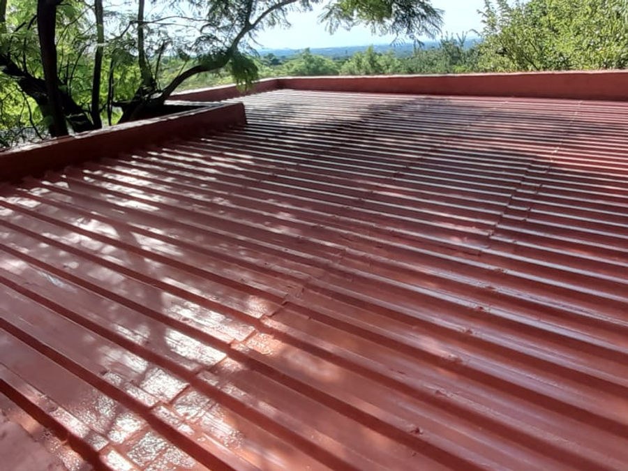 A red steel roof freshly coated