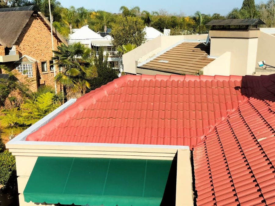 A red tiled roof above a green awning